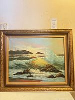 Front view of framed seascape oil painting