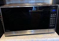 Front view showing full microwave, control panel, size