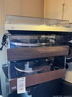 Stacked view of three turntables: JVC top, unidentified middle, Pioneer bottom