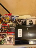 Console front with stack of 11 games