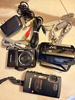 Overview of three cameras with cables and power adapter