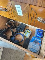 Drawer view with Walkmans, headphones, power adapters and cables