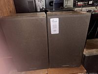 Front view of both Realistic speakers showing overall appearance and grille condition