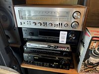 Stack of five audio components on shelf