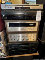 Front view of stacked components: Samsung DVD player, Toshiba player, two Marantz stereos, Pioneer stereo