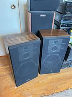 Two Technics SB-2525 floor speakers with grilles in place
