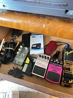 Overview of pedals, tuners, strap, cable and tuning machines in drawer