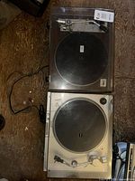 Two turntables stacked, showing overall condition and cords