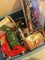 Assorted boxed and loose vehicles in bin
