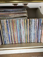 Full view of vinyl records on lower shelf