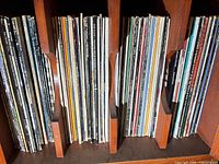 Three shelf sections filled with vinyl LPs