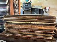 Side view of stacked vinyl LPs showing quantity and edge condition