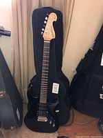Full view of Washburn electric guitar standing in soft gig bag