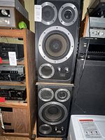 Both Wharfedale E50 speakers stacked, showing drivers, controls and grilles