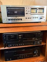 Front view of Sharp RT-1157 cassette deck stacked above two black components