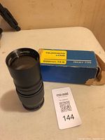 Lens standing next to original box