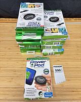 Stack of boxed PowerPod chargers, count visible