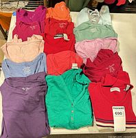Group view of all folded tops displaying colors and quantity