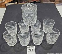 Eight Waterford tumblers and one biscuit jar with lid displayed together