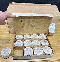 Open inner box showing 12 ceramic trinket boxes with sand dollar lids inside original shipping carton