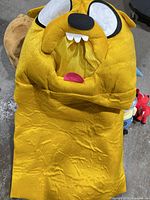 Yellow dog character plush hood visible among lot items