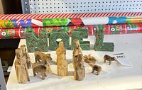 Lot overview showing NOEL letters, nativity figures, wrapping paper rolls