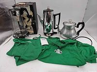 Full lot showing Corning carafe on stand, GE percolator, Royal electric pot, two Starbucks aprons
