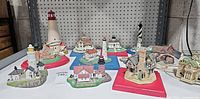 Group shot of all lighthouse and house figurines on table