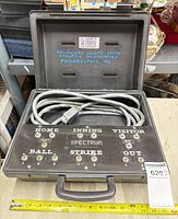 Open case showing control panel and coiled cable