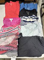 All nine folded tops laid out showing colours and patterns