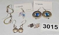All five pairs of earrings arranged together with two Earignals pairs on cards and three uncarded pairs