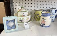 Full lot showing boxed Wedgwood ornament, fruit motif serving pieces and two pitchers