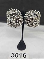 Front view of both earrings on stand showing pavé rhinestones