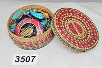 Basket with lid off showing mixed costume jewelry