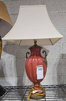 Full view of lamp with shade on shelving