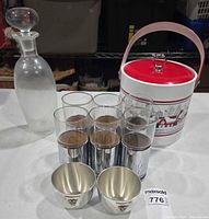 Group shot showing ice bucket, decanter, six chrome highball glasses, two pewter cups