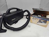Oreck canister vacuum with hose and Black+Decker iron boxed