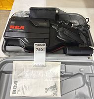 Camcorder, battery, power adapter and cords arranged inside carry case