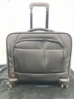 Front view of Samsonite rolling laptop bag showing zip pocket, handle, wheels