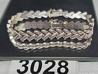 Top view of sterling silver chevron-link bracelet showing clasp and hallmarked links