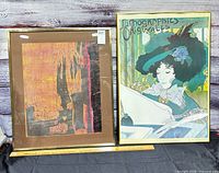 Both framed prints side by side with ruler for scale