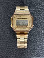 Front view of Casio gold-tone digital wristwatch displaying time