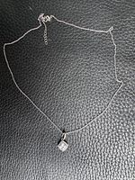 Full view of sterling chain and pendant on black background