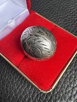 Top view of sterling silver dome ring showing etched leaf design