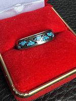 Ring front view showing turquoise chip inlay and silver separators