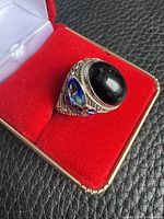 ring in box showing cabochon and filigree