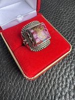 Front view of sterling silver ring with rectangular pink cabochon