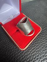 Front view of wide sterling silver ring in red box showing open cut-out design
