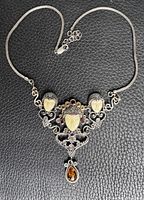 Full view of sterling silver necklace on black background