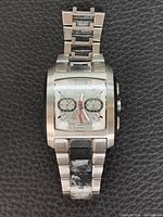 Full view of watch showing broken bracelet and dial